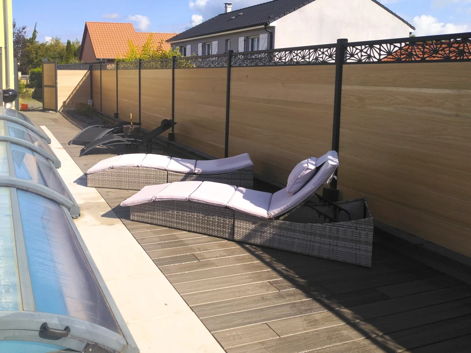 Terrasse extérieure en lames de bois naturel clair, bordée d'un jardin minéral avec gravier blanc